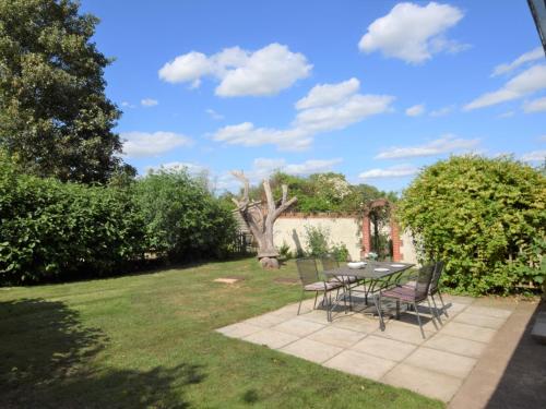a patio with a table and chairs in a yard at 2 Bed in Thetford 64075 in East Harling