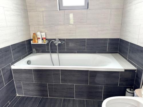 a bathroom with a bath tub and a toilet at Villa Valentina in Metogjashta