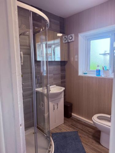 a bathroom with a shower and a toilet at Spacious Room in Manchester in Middleton