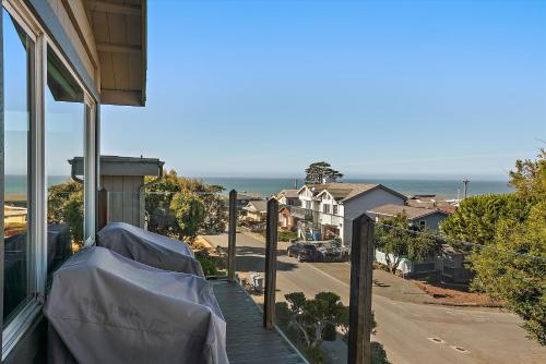 a house with a covered porch with a view of the ocean at Pembrook Paradise Monthly Rental Only in Cambria