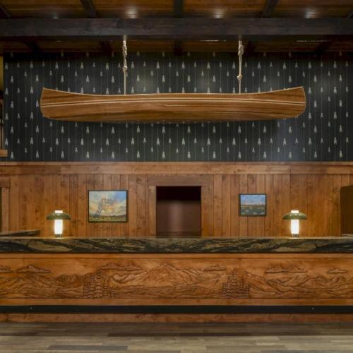a large boat hanging from the wall of a courtroom at Wayfinder Bishop in Bishop