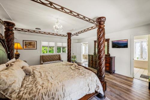 a bedroom with a large bed with a wooden frame at Mountain View Mansion in Gatlinburg