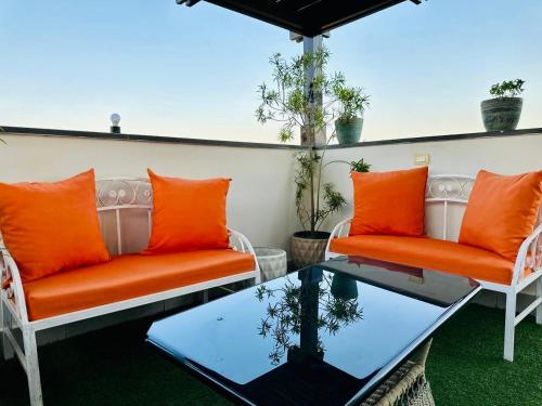 two orange chairs and a table on a patio at Mirage residence resort in Cairo