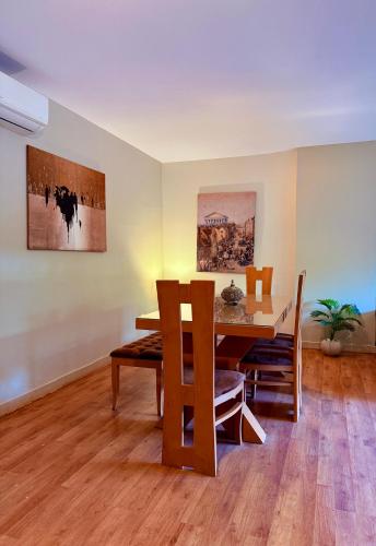 a dining room with a wooden table and chairs at Mirage residence resort in Cairo