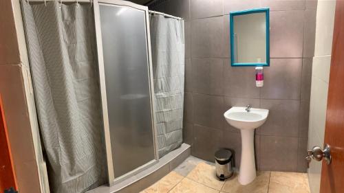 a bathroom with a shower and a sink at AQP Hostel Company in Yanahuara