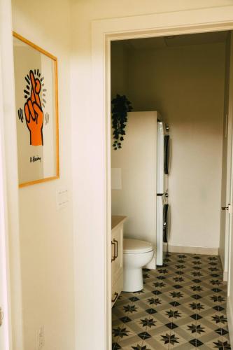 a bathroom with a white toilet and a black and white floor at NEW Cozy Downtown Halifax Loft Free Parking in Halifax