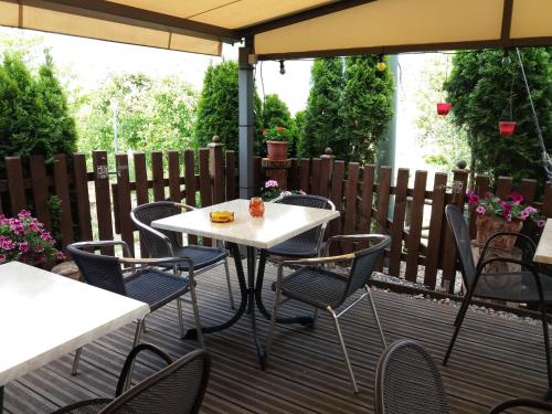 a table and chairs on a deck with an umbrella at B&B - Apartments Sunnwies in Marlengo