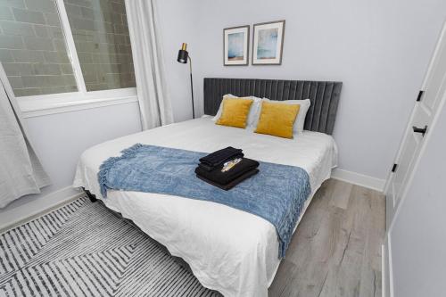 a small bedroom with a bed with a suitcase on it at Spacious 3BR Family Oasis Sleeps 8 with Free Parking Near Medical District, Douglas Park and University of Illinois Chicago in Chicago