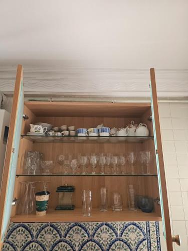 a cupboard with glasses and other items on it at Le Bon coin in Hammamet Nord