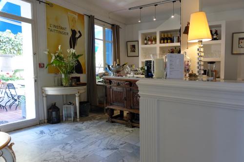 a room with a counter and a window at Hotel Normandy in Cap d'Ail