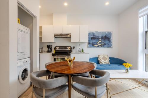 a kitchen with a table and chairs in a room at Peaceful 1BR Getaway Near MTL Village in Montréal