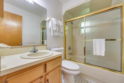 a bathroom with a toilet and a sink and a shower at East Palatka Vacation Rental, Anglers Paradise in East Palatka