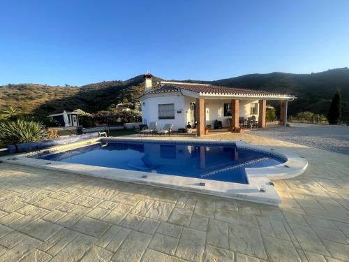 a swimming pool in front of a house at Luxury Pool Villa in Arenas - Andalusia in Los Valverde