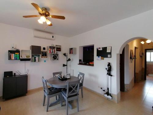 a dining room with a table and a ceiling fan at Luxury Pool Villa in Arenas - Andalusia in Los Valverde
