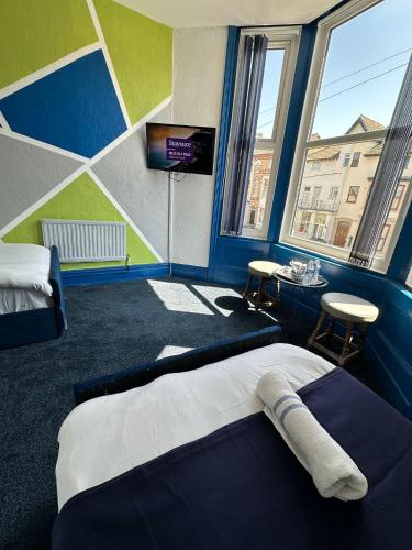 a room with two beds and a tv in it at Elite Hotel Blackpool in Blackpool
