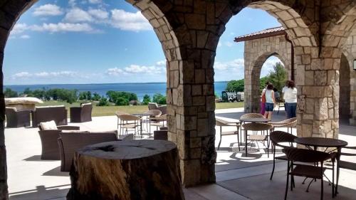 a patio with tables and chairs and a view of the ocean at Gorogeous Chic 2BDR Renovated Home near Downtown Sleeps 6 843 in Traverse City