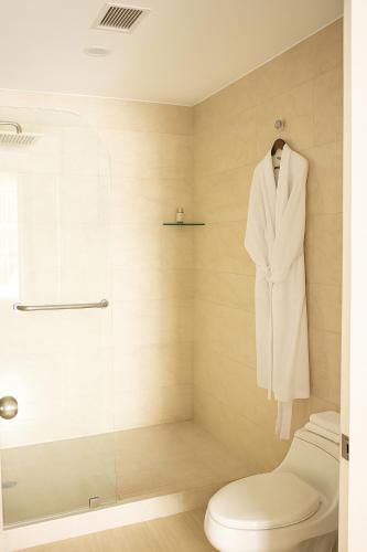 a white suit on a mannequin in a bathroom at K Suites in Quito