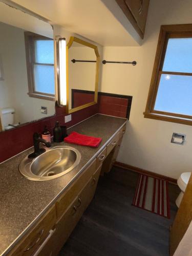 a bathroom with a sink and a mirror at Merlot House in Calgary