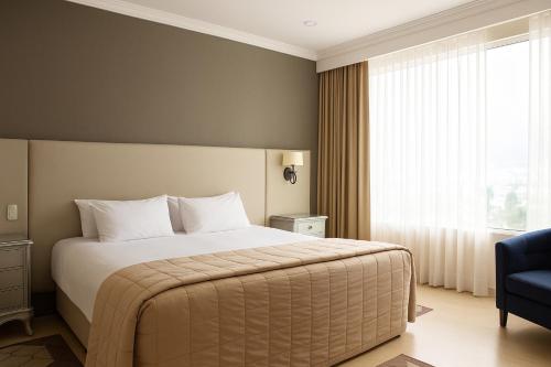 a bedroom with a large bed and a window at K Suites in Quito