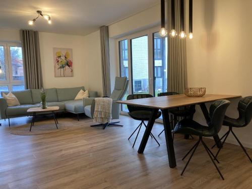 a living room with a table and a couch at Dahmer-Duenen-Ostseezauber in Dahme
