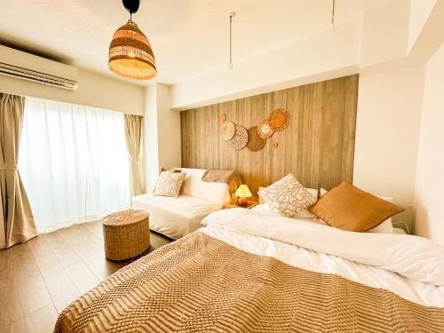 a living room with a bed and a couch at Syforme Keikyu-Kamata Residence in Tokyo