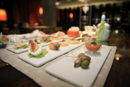 a table with several plates of food on it at Hotel Les Champs Hualien in Hualien City