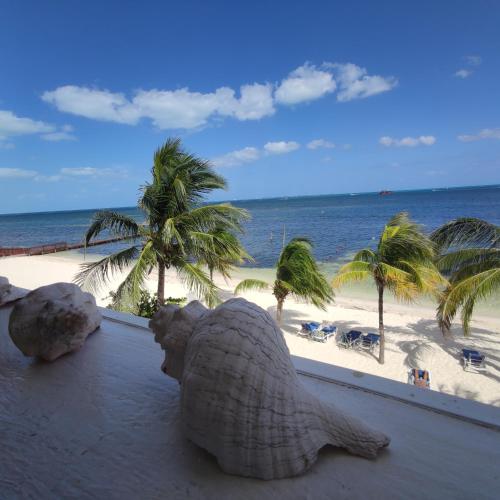 a statue of an elephant on a balcony overlooking the beach at Bella Beach Condo Cancun in Cancún