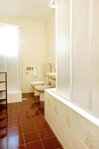 a bathroom with a toilet and a tub and a sink at Apartments with parking space Korcula - 180 in Korčula