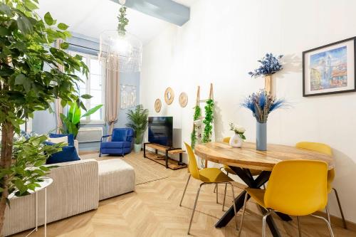 - un salon avec une table en bois et des chaises jaunes dans l'établissement Boho Chic Apartment in Old Town, à Nice