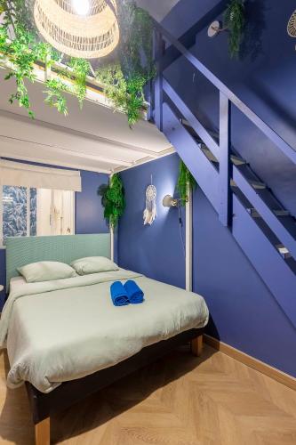 - une chambre bleue dotée d'un lit avec des chaussures bleues dans l'établissement Boho Chic Apartment in Old Town, à Nice