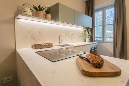 a kitchen with a cutting board on a counter at V Suite on Lake Como By Rent All Como in Como