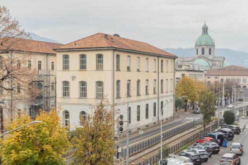 a city street with cars parked in front of buildings at V Suite on Lake Como By Rent All Como in Como