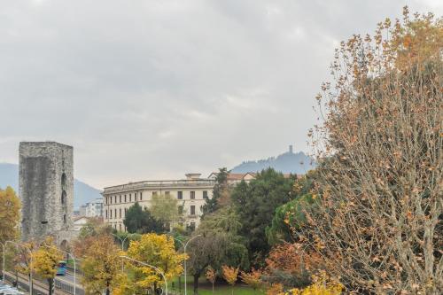 a view of a city with a castle and trees at V Suite on Lake Como By Rent All Como in Como