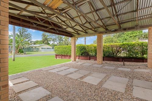 an outdoor patio with awning and a lawn at Coastal Bliss at Kinka Beach! in Kinka