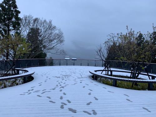 a snow covered walkway with footprints in the snow at Green Field Mountain Villa in Hualing