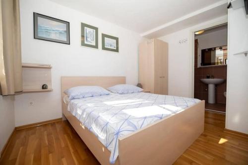 a bedroom with a bed and a sink in it at Family-friendly apartments with swimming pool Lic, Gorski kotar - 23685 in Fužine