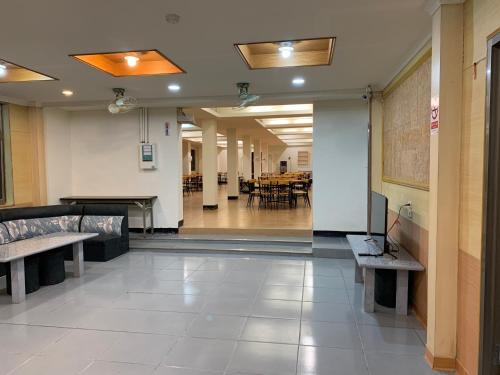 a hallway with benches and tables in a building at Green Field Mountain Villa in Hualing