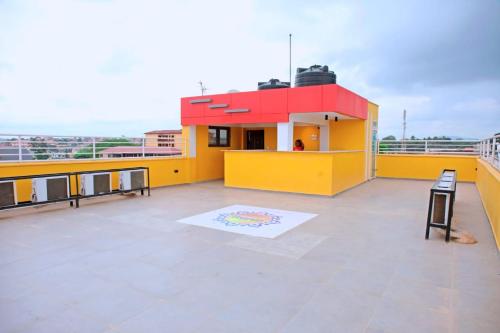 a yellow and red building on top of a roof at Texas Royal Lodge Hotel in Janman