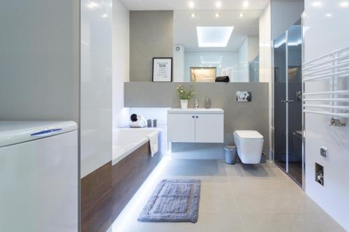 a bathroom with a toilet and a sink at VIP Apartamenty Stara Polana in Zakopane