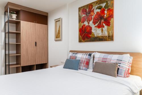a bedroom with a large white bed with pillows at Hua Hin La Casita Beautiful Two Bedroom Condo With Great Views in Hua Hin