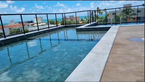 a swimming pool on top of a building at Flat Brisa do Mar - Centro Porto - 300 metros das piscinas naturais in Porto De Galinhas