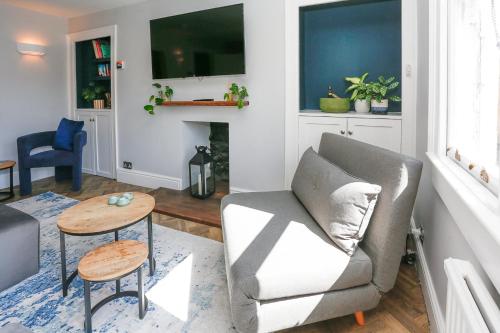 a living room with a couch and a table at Top Floor at 13 Rivers Street in Bath
