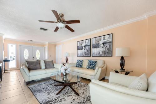 a living room with a couch and a ceiling fan at Renovated 3BR Dog Friendly Pond View WD in Whitfield