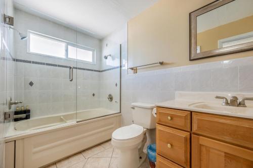 a bathroom with a toilet and a sink and a shower at Renovated 3BR Dog Friendly Pond View WD in Whitfield