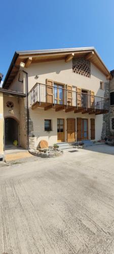 a large building with a balcony and a driveway at BALLABIO LAKE - Rustic Chic Retreat in Ballabio