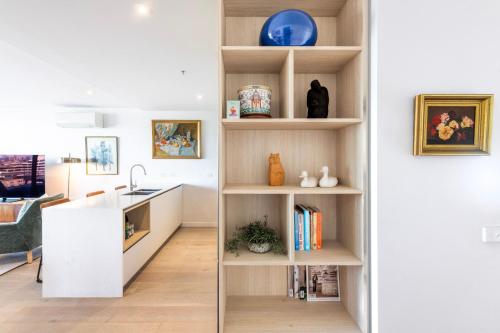 a kitchen with white shelves and a sink at Wellness and Style - 2BR Apartment with Pool, Hot Tub and Gym in Melbourne