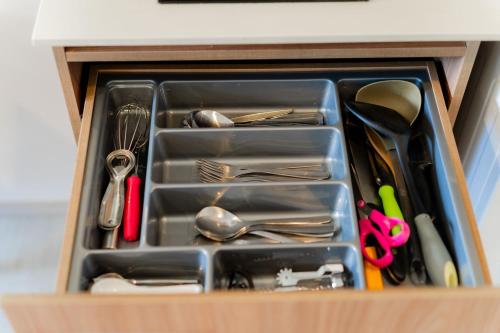 a drawer full of utensils in a wooden box at Hua Hin La Casita Beautiful Two Bedroom Condo With Great Views in Hua Hin