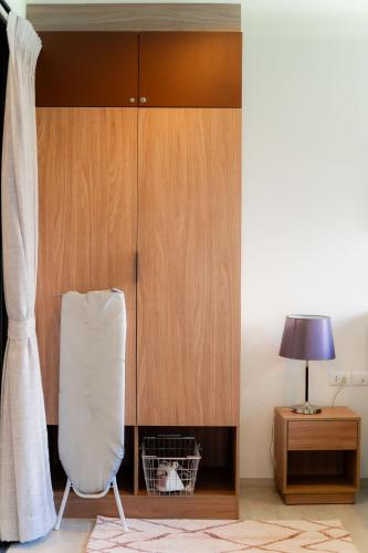 a room with a white chair and a wooden cabinet at Hua Hin La Casita Beautiful Two Bedroom Condo With Great Views in Hua Hin