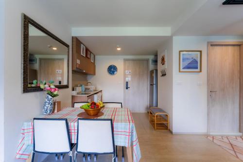 a kitchen and dining room with a table and chairs at Hua Hin La Casita Beautiful Two Bedroom Condo With Great Views in Hua Hin