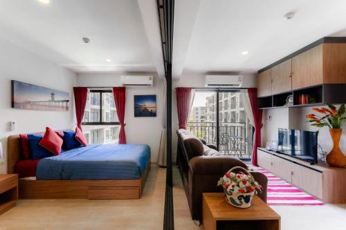 a bedroom with a bed and a couch and a window at Hua Hin La Casita Beautiful Two Bedroom Condo With Great Views in Hua Hin